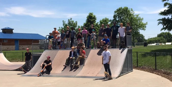 A group of peaple standing at one of the Park District's skate parks
