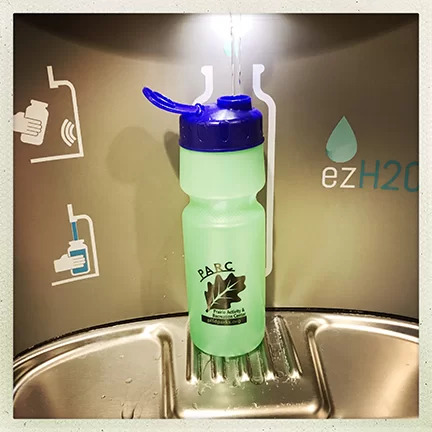 Water bottle being refilled at a refill station